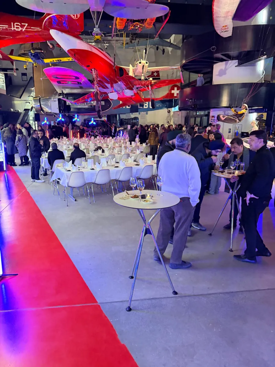 Guests enjoying a themed dinner beneath historic aircraft displays