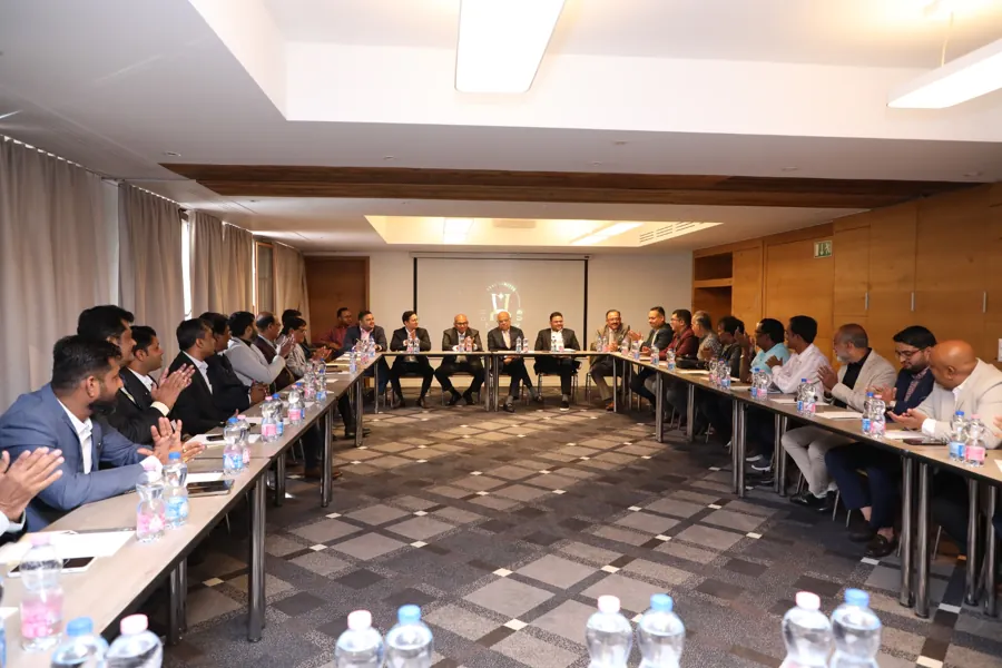 Delegates seated around a U-shaped conference table