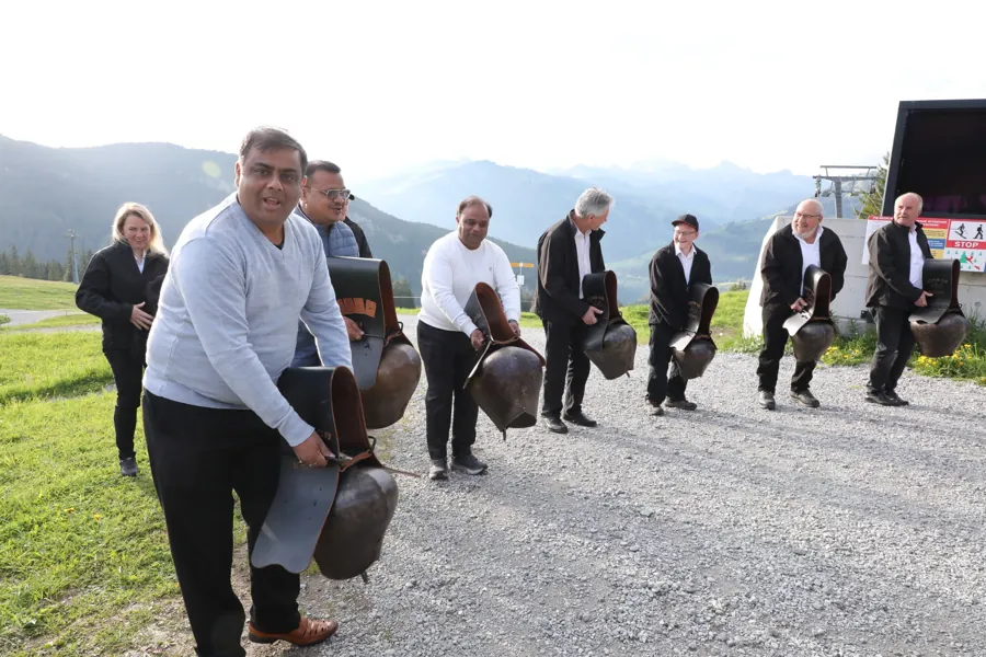 Guests taking part in a Swiss cowbell experience outdoors
